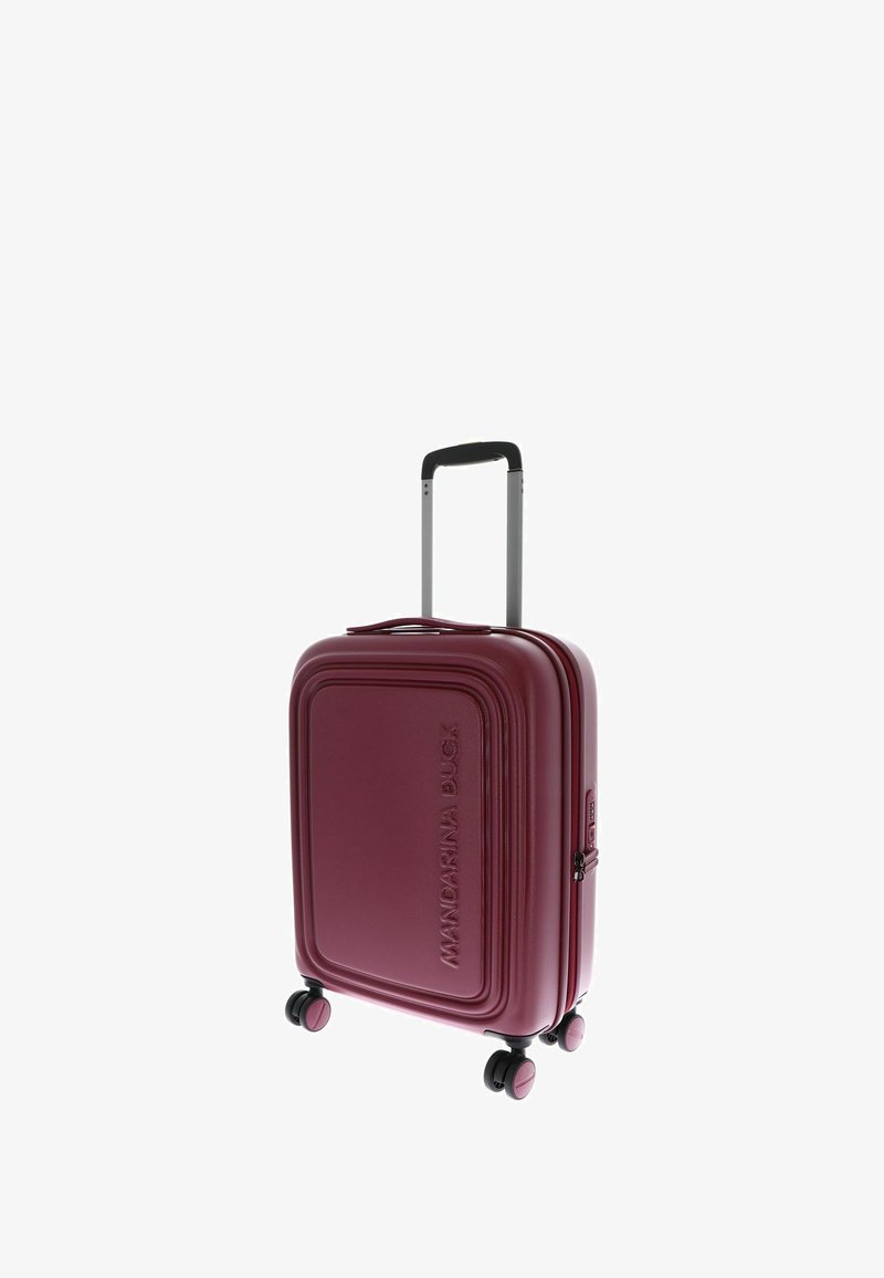 Hard-shell suitcase in deep burgundy, featuring a textured finish, retractable handle, four compact wheels, and zipper closure.