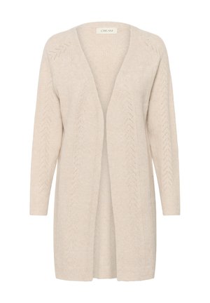 Cardigan beige en tricot doux. Il présente une ouverture sur le devant, des manches longues et de délicates bordures en dentelle en zigzag le long des bords.