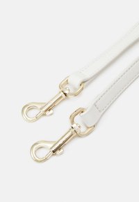 White leather strap with two gold-tone metal clips. Features smooth texture and stitching along edges. No visible patterns or accents.