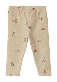 Beige leggings van zachte stof, met een herhalend patroon van kleine paarse strikjes. Elastische tailleband aan de bovenkant.