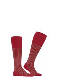 Calze rosse al ginocchio con strisce verdi verticali. Realizzate in un tessuto morbido con una texture a costine sulla parte superiore e sul piede.
