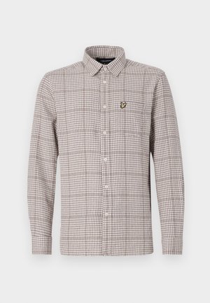 Kockovaná košeľa na gombíky v béžovej a hnedej farbe, s dlhými rukávmi, golierom a malou vyšitou nášivkou na vrecku na hrudi.