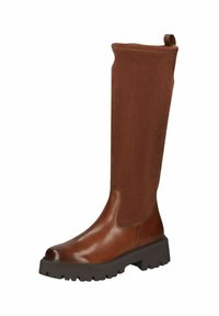 Botas marrones hasta la rodilla, hechas de cuero suave y gamuza, con una suela de goma gruesa y una lengüeta en la parte trasera para ponérselas fácilmente.