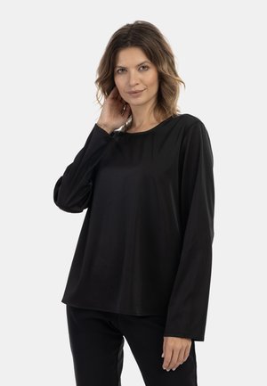 Black long-sleeve top in a smooth, lightweight fabric with a rounded neckline and relaxed fit, featuring minimal seam detailing.