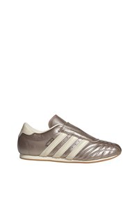 Metallic bronze slip-on shoe with cream accents, a textured surface, and three stripes on the side. Rounded toe and flat sole design.