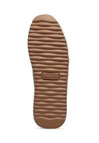 Suola di scarpa in gomma con un motivo testurizzato ondulato e un'etichetta rettangolare al centro. Il colore è marrone con un bordo superiore beige.