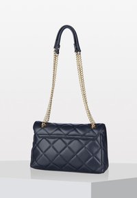 Navy quilted leather handbag with a rectangular shape, gold chain strap, and a smooth texture. Features a flap closure and minimal hardware.