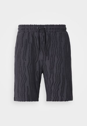 Pantalones cortos negros con un patrón de olas texturizado, cinturilla elástica y cordón ajustable, hechos de una tela suave y ligera.