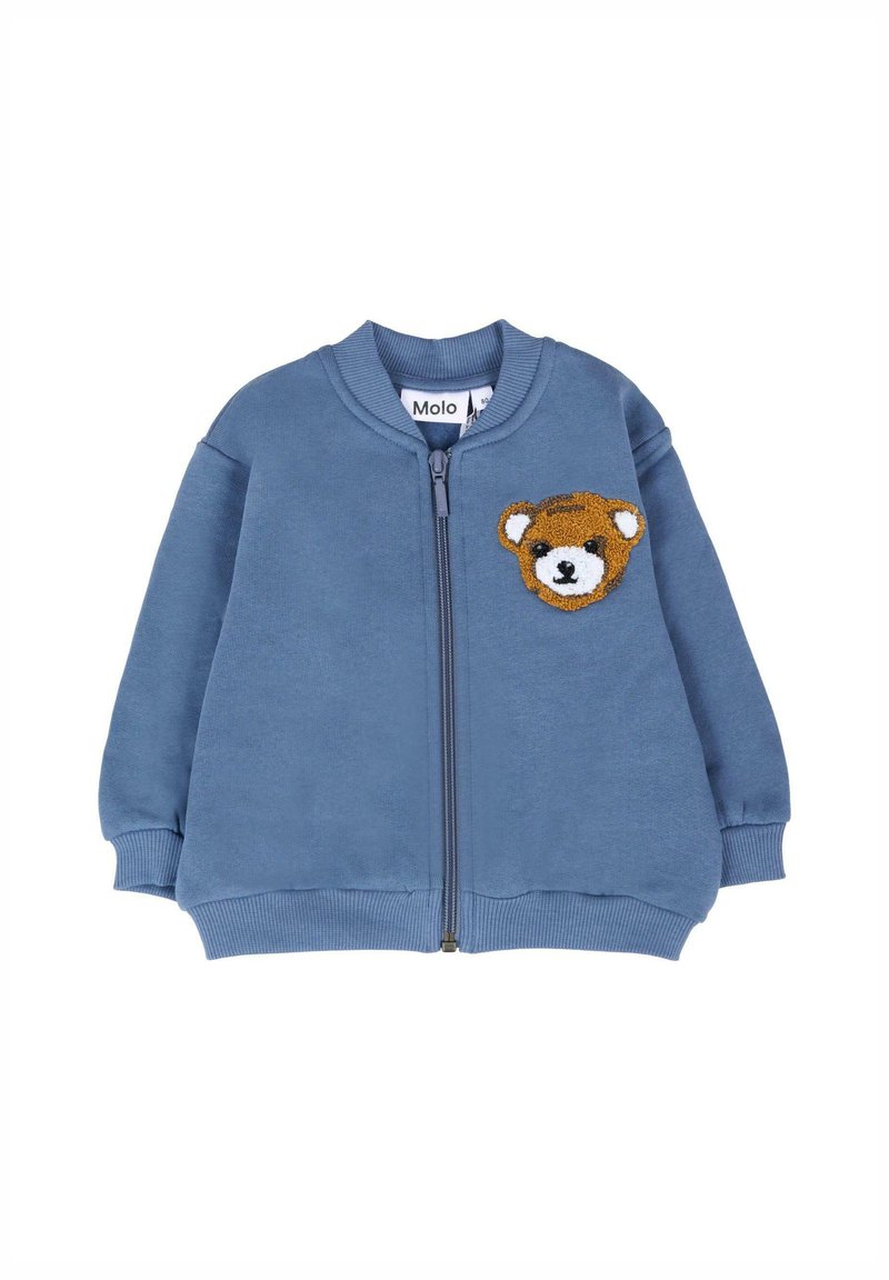 Felpa zip-up blu realizzata in morbido cotone. Presenta un'applicazione a forma di orsetto sul lato sinistro del petto e polsini e fondo a costine.