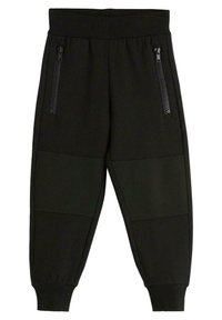 Schwarze Jogginghosen mit geribbeltem Bund, zwei seitlichen Reißverschluss-Taschen und strukturierten Mesh-Einsätzen an den Unterschenkeln. Verstellbare Bündchen.
