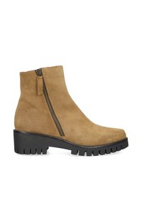 Tan suede ankle boot with black chunky treaded sole and side zipper on white background.