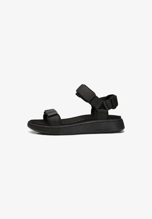 Black sandal with a flat sole, adjustable strap design, soft fabric upper, and textured accents, suitable for casual wear.