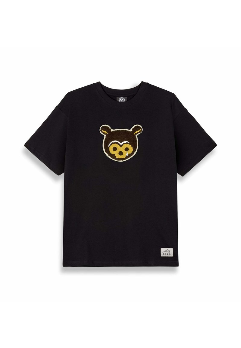 Camiseta de algodón negra con un aplique texturizado de la cara de un oso marrón en el frente. Mangas cortas, cuello redondo, con una pequeña etiqueta en el dobladillo.