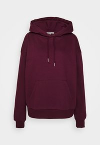 Sudadera con capucha de color burdeos, con bolsillo tipo canguro, puños y dobladillo acanalados. Fabricada con una tela suave, de corte holgado y con cordón ajustable.