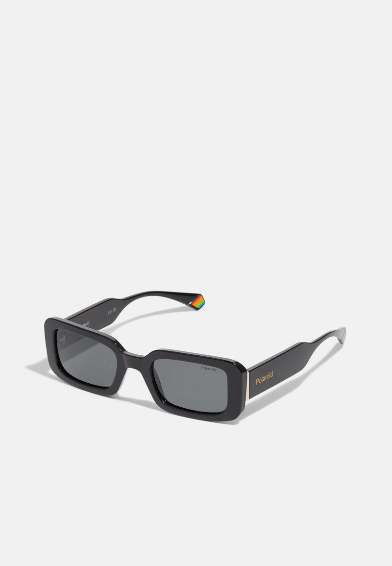 Rectangular black sunglasses with dark lenses, featuring a gold logo on the temple and a colorful striped accent on the arm.