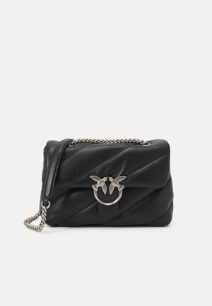 Black leather handbag with quilted design, featuring a silver bird-shaped clasp and a chain strap. Smooth texture, structured shape.