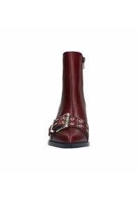 Burgundy leather ankle boot with a sleek design, featuring a silver buckle and eyelets across the front, and a side zipper for closure.