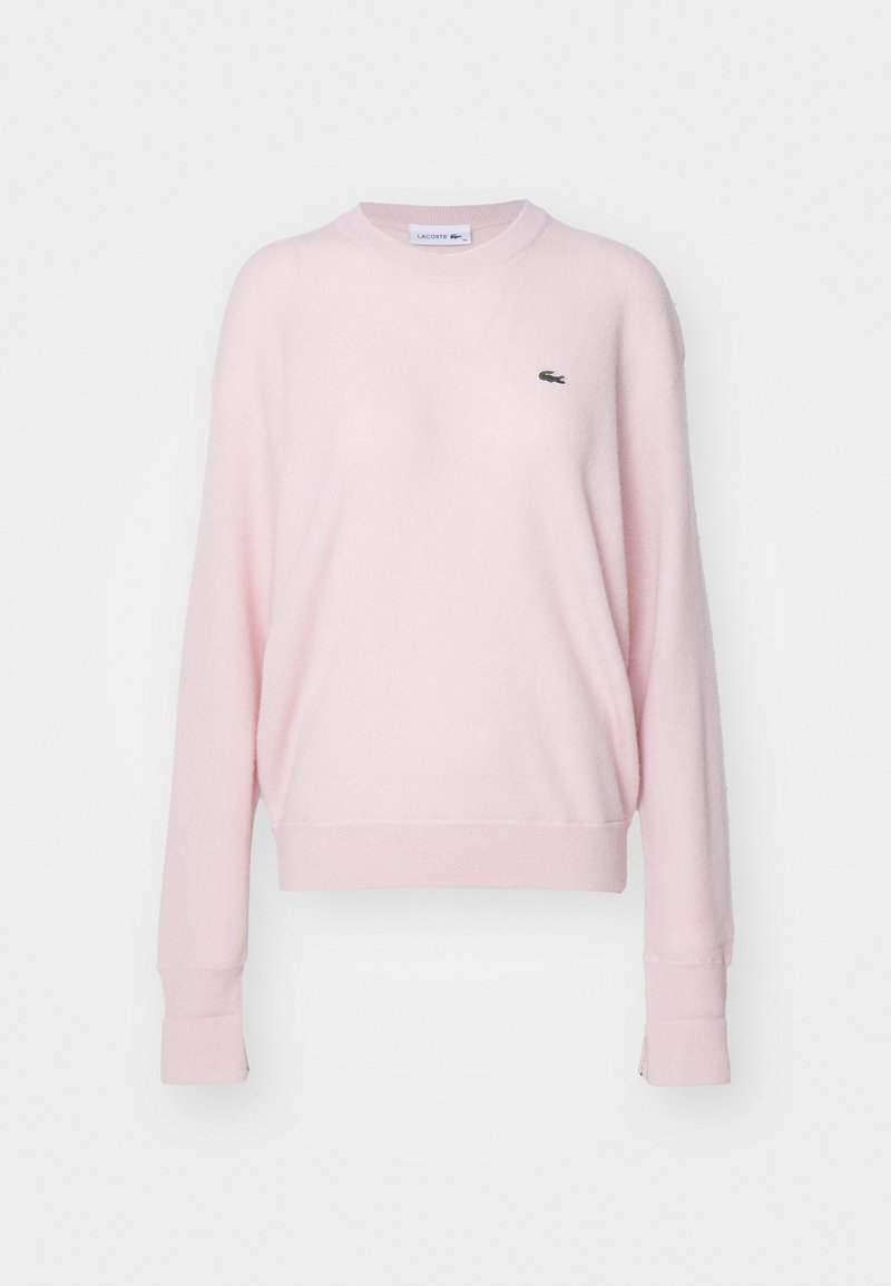 Helles rosa Sweatshirt aus weichem Stoff, mit einem runden Halsausschnitt, langen Ärmeln und einem kleinen grünen Krokodil-Logo auf der Brust.
