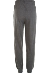 Grå träningsoverallar med elastisk midja och muddar, med en jämn textur och avslappnad passform. Inga synliga fickor eller mönster.