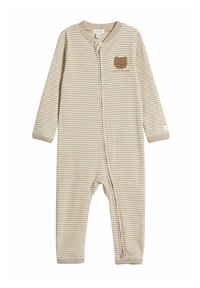 Beige och krämrandig overall med långa ärmar, med ett björnmotiv och en dragkedja fram. Tillverkad av mjukt tyg med en strukturerad känsla.