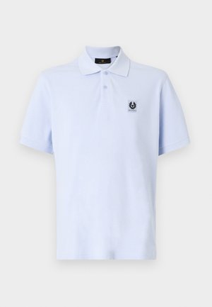 Light blue polo shirt with a soft texture, short sleeves, and a classic collar. Features a small logo patch on the left chest.