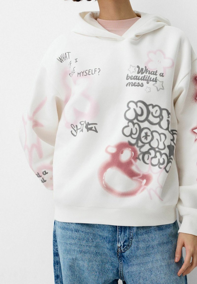 Felpa bianca con cappuccio caratterizzata da diverse stampe grafiche in rosa, nero e grigio, inclusi testi e disegni, tessuto testurizzato e polsini a coste.