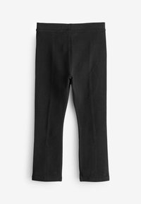 Schwarze Leggings aus dehnbarem Baumwollmaterial. Schlichtes Design mit elastischem Taillenbund, keine Muster oder Akzente. Flach liegende Position.