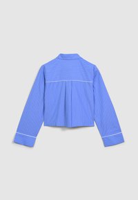 Chemise à manches longues bleu clair avec des rayures blanches, dotée d'un pli dans le dos et d'une bordure blanche aux poignets et au col. Texture de tissu lisse.