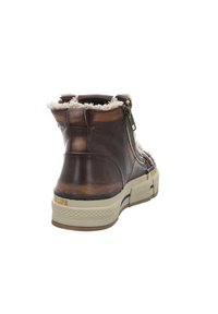Brown leather ankle boot with faux fur lining, side zipper, and textured sole. Rounded toe and low-profile design. Accented with stitching details.