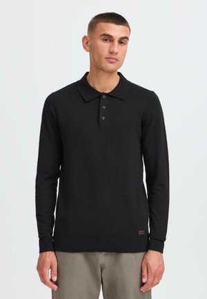 Black long-sleeve polo shirt with a collar, featuring three button placket, ribbed cuffs, and hem, made from a soft knit material.