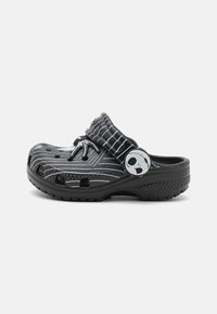 Black and gray clogs with a striped design, featuring ventilation holes and a side logo accent. Textured sole for grip and comfort.