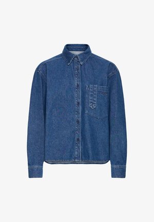 Kék farmer gombos vidéki ing hosszú ujakkal, mellzsebbel és gallérral. Jellemzője egy kicsit laza szabás és a texturált anyag.