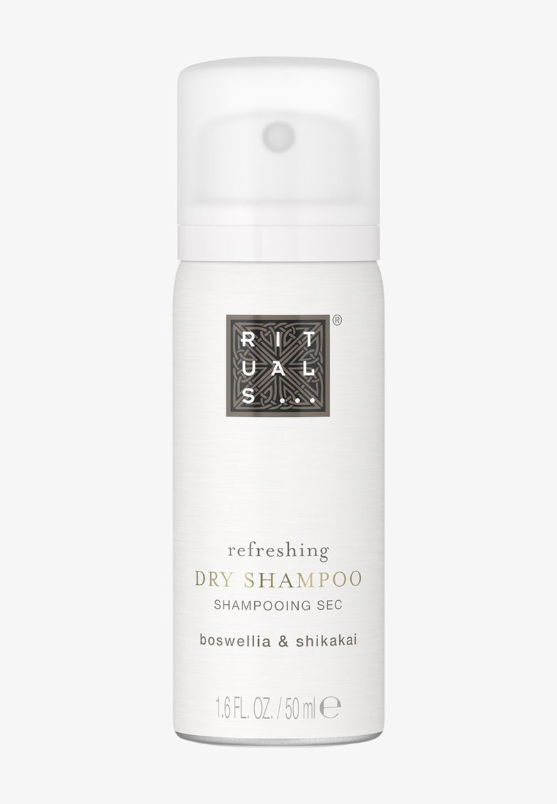 Vit cylindrisk kanister med ett glänsande vitt lock. Etiketten har svart och guld text som detaljerar produkt och ingredienser. 1,6 fl oz.