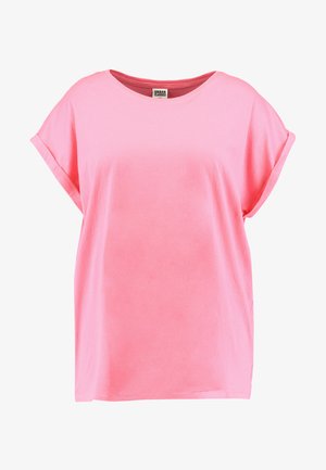 Svijetlo ružičasta majica kratkih rukava od mekog pamuka. Ima okrugli izrez i labav, opušten kroj s preklopljenim rukavima.