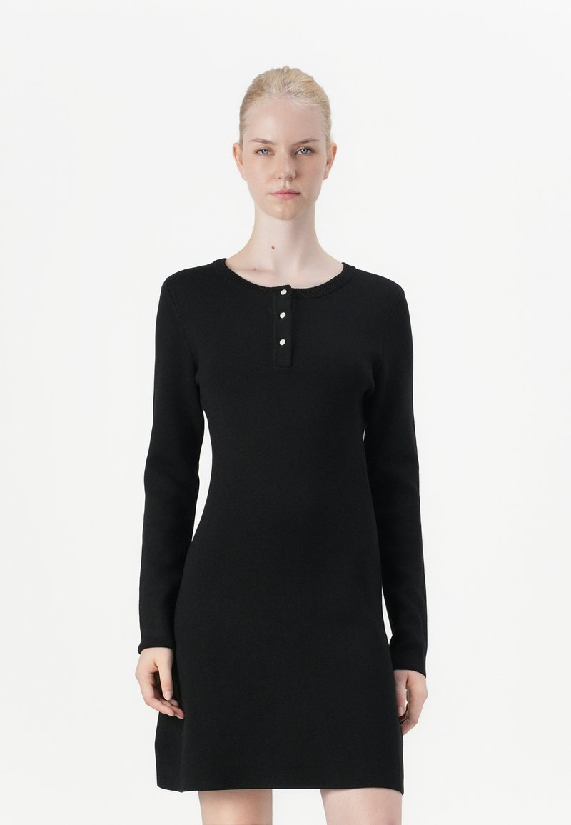 Black, long-sleeve dress with a round neckline. Features three-button placket and a fitted bodice that flares slightly at the hem. Smooth texture.