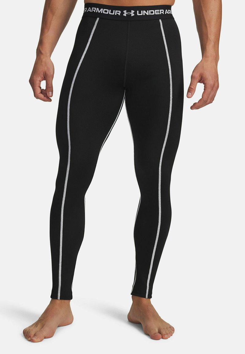 Black athletic leggings with a textured finish, featuring contrasting white side stripes and an elastic waistband with branding.