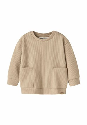 Pull bébé beige à côtes, manches longues, avec deux poches à l'avant et un col rond, en tissu doux.