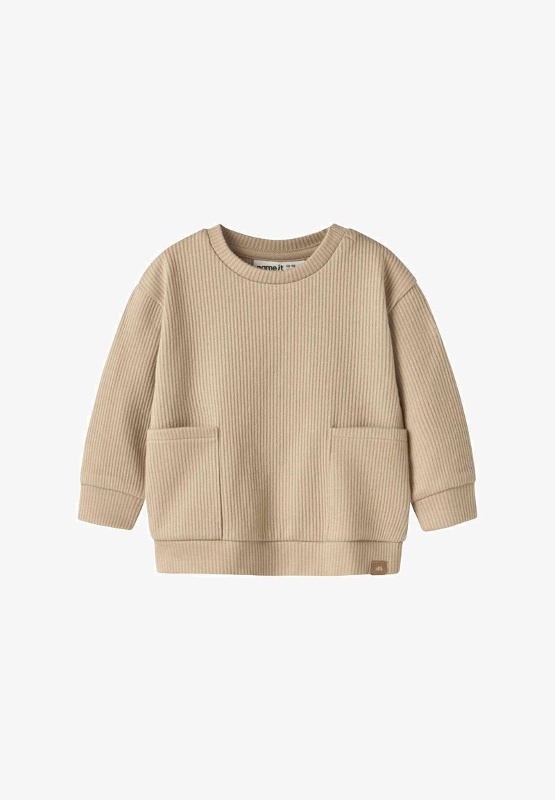 Pull bébé beige à côtes, manches longues, avec deux poches à l'avant et un col rond, en tissu doux.