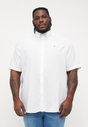 White short-sleeve button-up shirt with a pointed collar. Features a small logo on the left chest and a relaxed fit. Smooth cotton fabric.