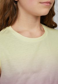 Lichtgeel T-shirt met korte mouwen en een ronde halslijn, met een gladde textuur en een subtiele gradient van geel naar zachtroze.