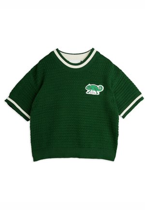 Mørkegrøn kortærmet strikket sweater med hvid kant på krave og ærmer, med en lille broderet kameleon-patch på brystet.