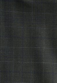Dark gray fabric with a fine textured weave and a subtle blue and light gray large checkered pattern.