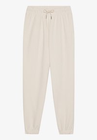 Beige Jogginghosen mit elastischem Bund und verstellbarem Kordelzug. Eng anliegende Bündchen an den Knöcheln. Weicher, strukturierter Stoff. Einfaches, vielseitiges Design.