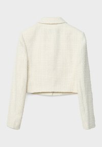 Veste courte en tweed crème à manches longues, avec un petit col et une finition en tissu tissé texturé.