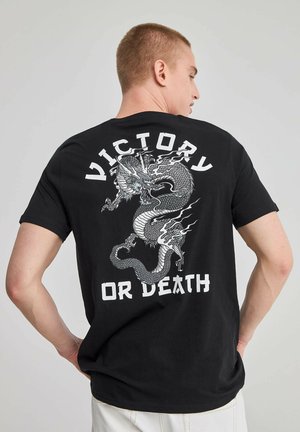 T-shirt in cotone nero con una grande grafica di un drago bianco e la scritta "VITTORIA O MORTE" sul retro; maniche corte, vestibilità rilassata.