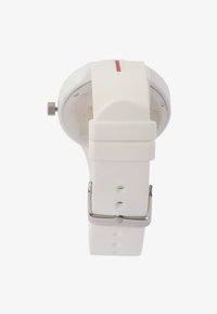 White silicone watch with a round face, silver hardware, and a red accent on the dial. Features adjustable strap and multiple hole settings.