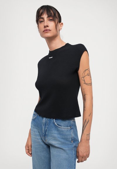 Black cropped t-shirt with a round neckline and cap sleeves, made from textured fabric. Features a small logo detail on the chest.