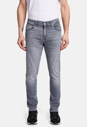 Gray denim jeans with a straight fit, five-pocket design, and light fading. Paired with black sneakers and a white t-shirt.
