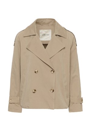 Giacca beige doppiopetto con bottoni color oro, ampi revers e tasche laterali. Presenta spalline e polsini regolabili.