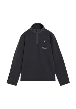 Jersey negro de manga larga con cuello alto, cremallera frontal parcial y un bolsillo en el pecho con botón y logo de Scalpers.